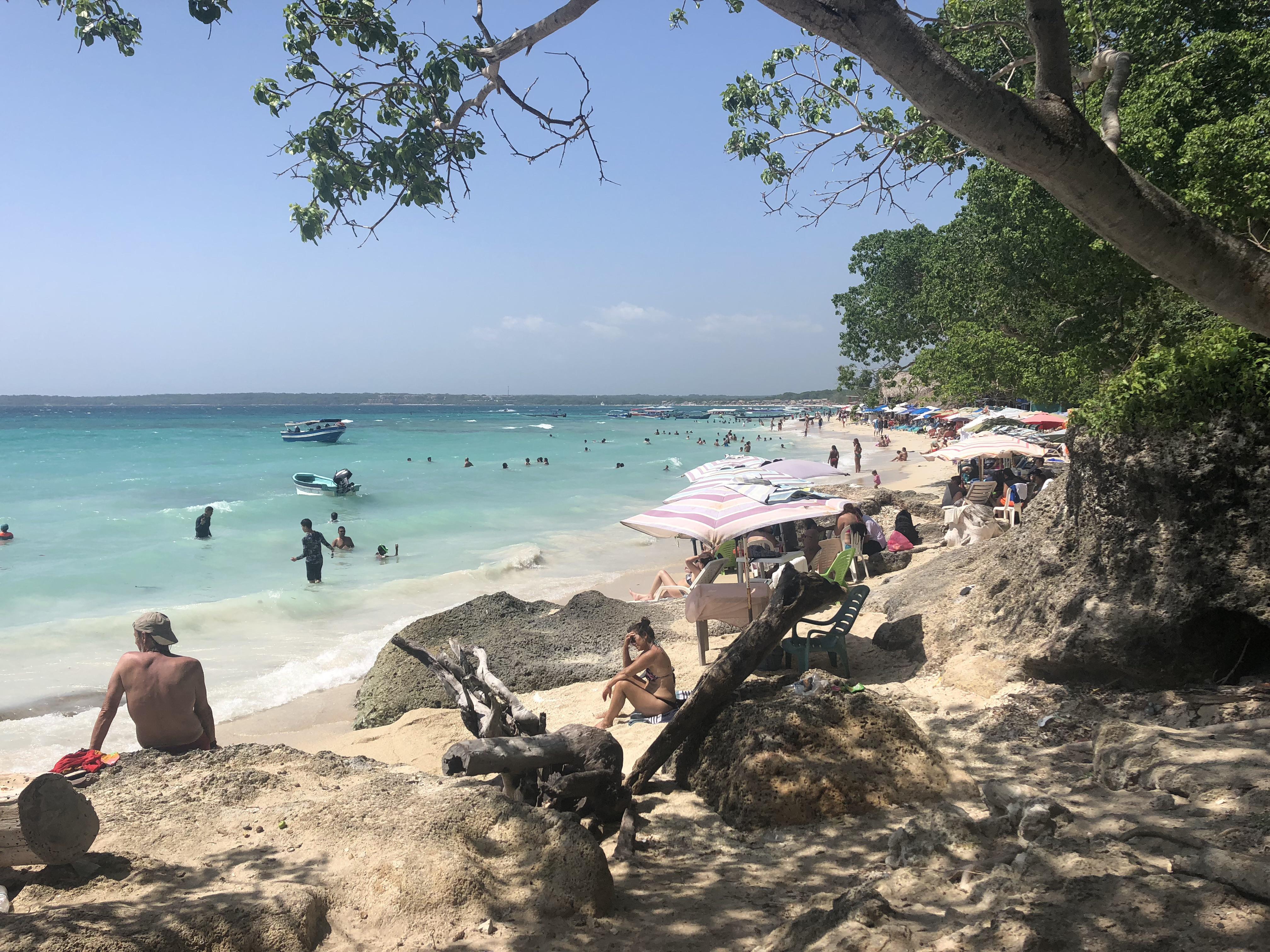 Caribbean coastal town in Colombia featuring beaches, city walls, a church, and night street views