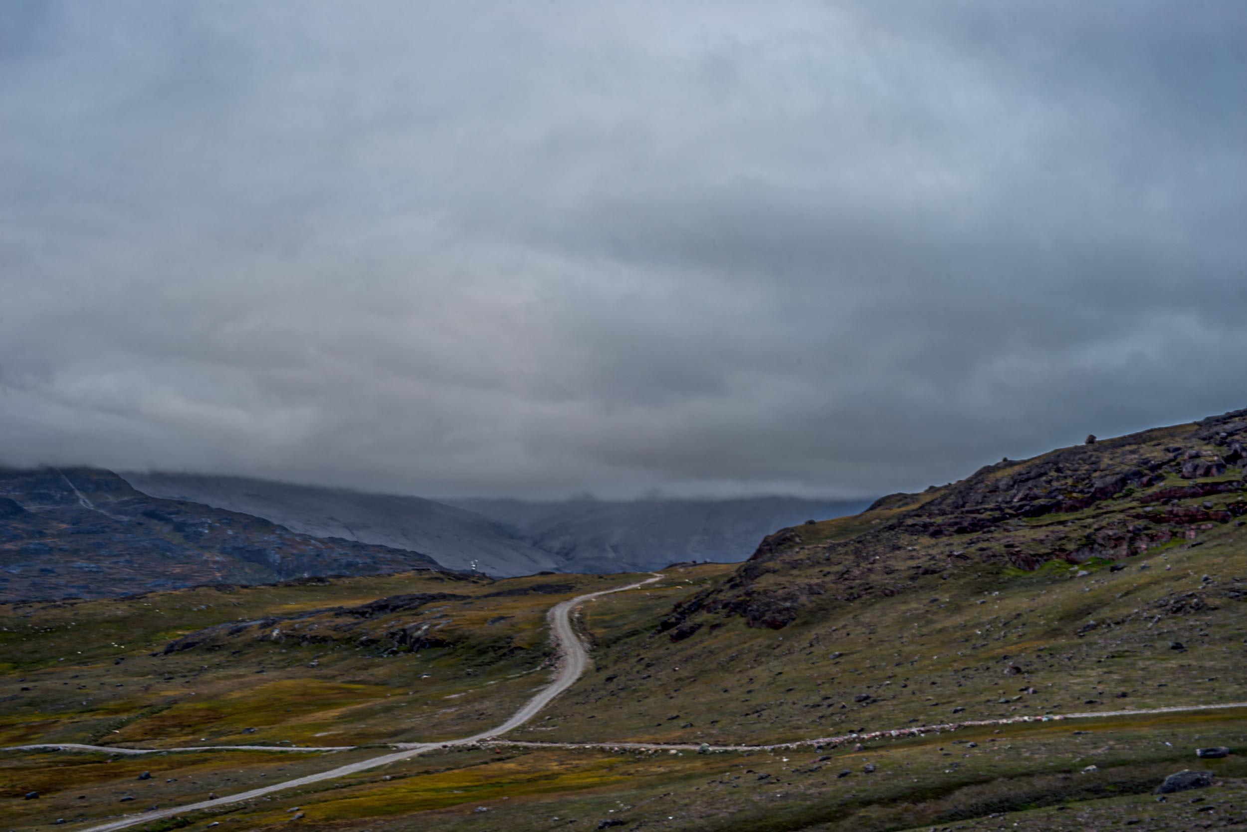 Greenland landscapes with mountains, glaciers, icebergs, a small cabin, and icy waters