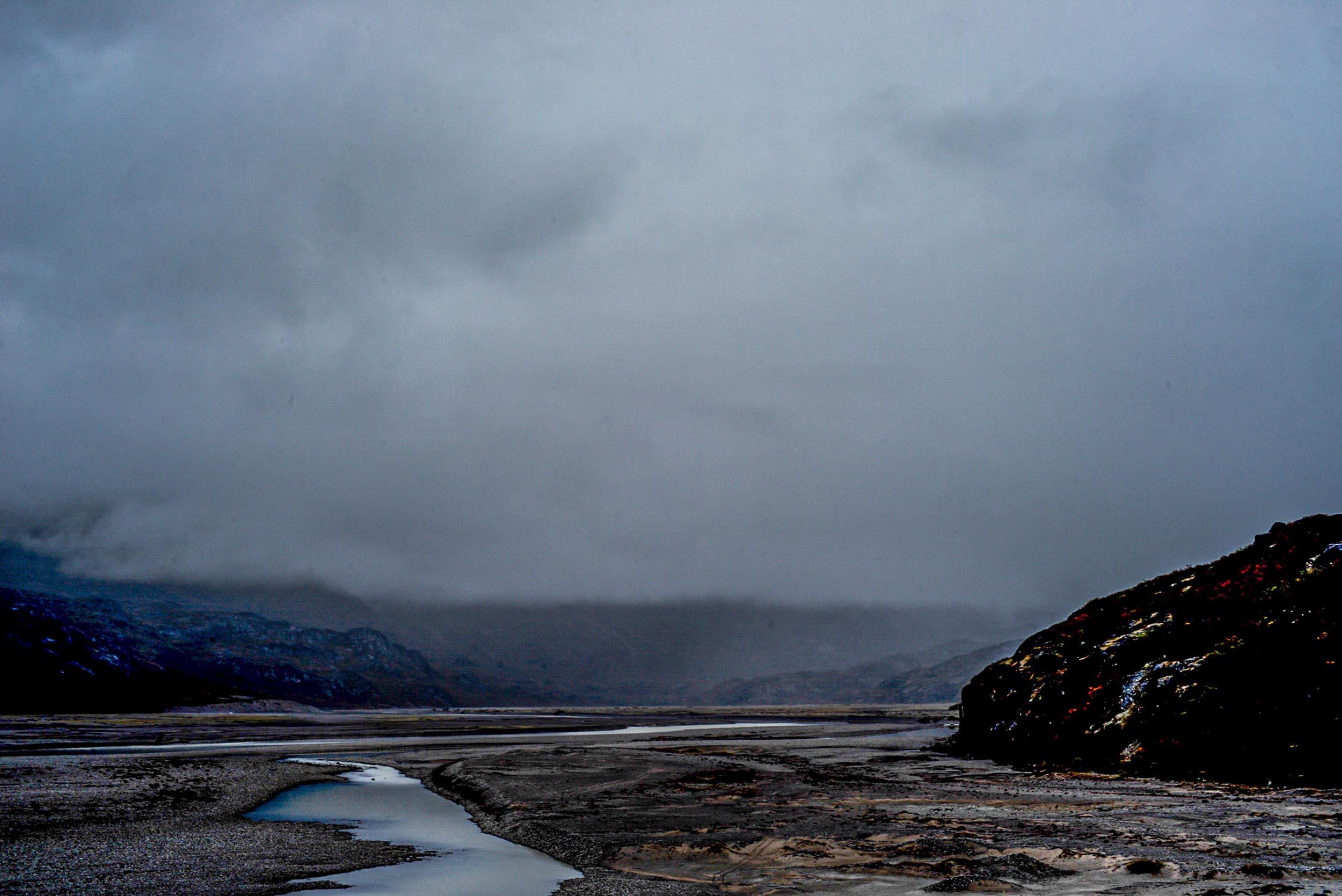Greenland landscapes with mountains, glaciers, icebergs, a small cabin, and icy waters