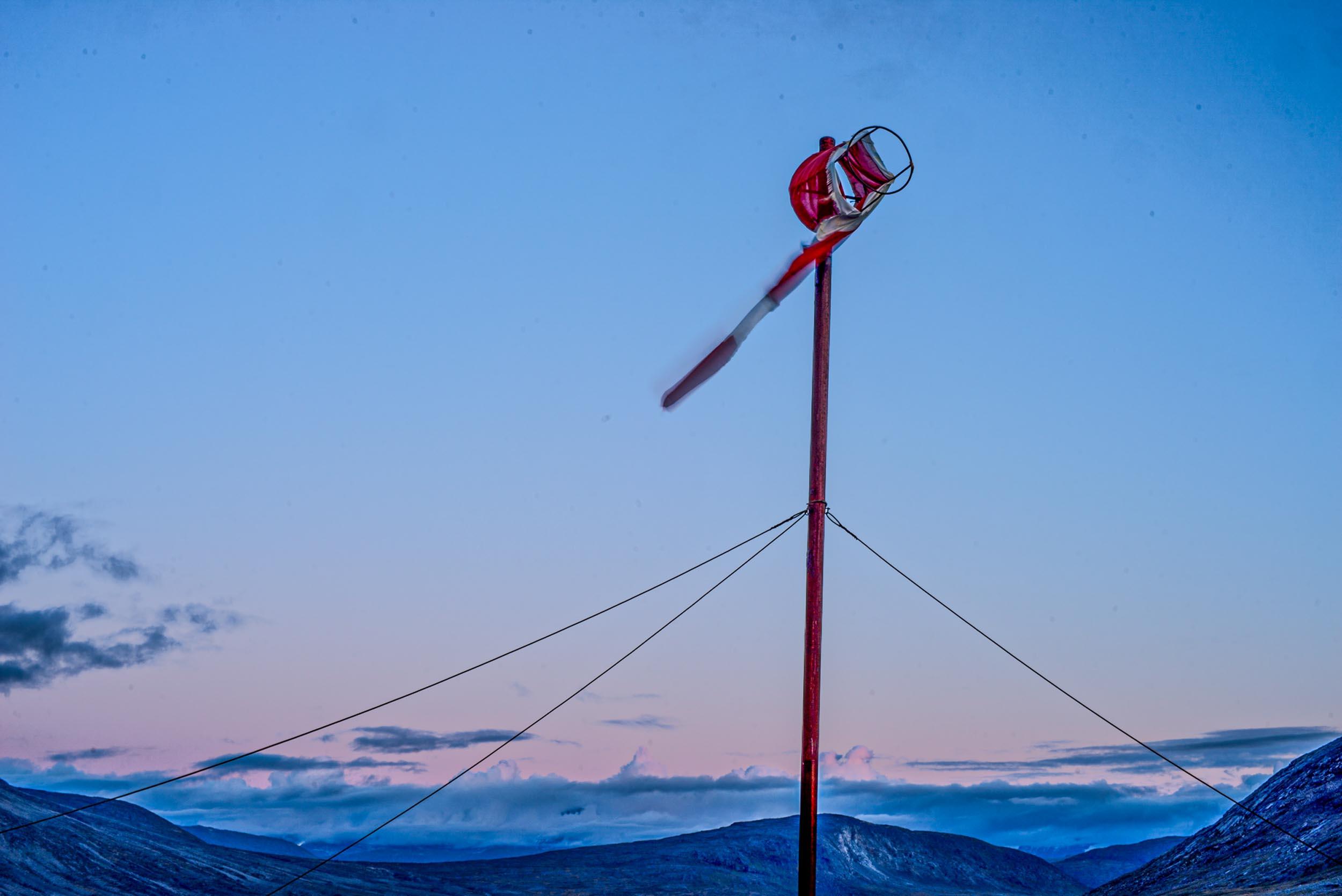 Greenland landscapes with mountains, glaciers, icebergs, a small cabin, and icy waters