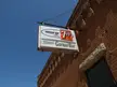 Vintage 7up and Fischer's Corner Bar sign on a red brick building in Elysian, Minnesota