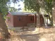 The restored Walker Cabin at Placerita Canyon State Park, a red wooden cabin with a vintage metal cart