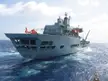 Wave Ruler A390 naval ship with a US Coast Guard Eurocopter HH-65 Dolphin helicopter on deck in the open ocean