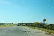K-254 westbound highway in El Dorado, Kansas, with a tanker truck and a WEST 254 road sign under a blue sky