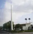 San Fernando Pastoral Region church building with a tall spire and cross surrounded by palm trees