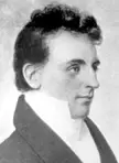 Robert Unwin Harwood in a black and white fine art oil painting, shown in profile wearing a high-collared white shirt.