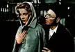 Virna Lisi in a grey hooded raincoat and Turi Pandolfini in a dark cap and round glasses