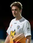 Đulbić wearing a white and orange Reebok Gold Coast United sports jersey