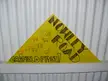 A yellow triangular sign with sheep illustrations and text reading 'NOWLEY ROAD GASFIELD FREE!' against a white wall.