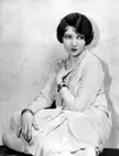Colbert in a white dress and pearl necklace for the Broadway production La Gringa, 1928
