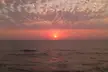 Sunset at Worli seaface with a calm ocean and scattered clouds