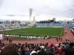 FC Shinnik Yaroslavl vs Spartak Moscow match with a green soccer field, blue seating, and a crowd in athletic wear