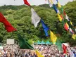 Fuji Rock Festival '10 crowd in a valley with green hills and colorful prayer flags