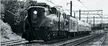 PRR GG1 locomotive 4935 pulling the Murray Hill passenger cars on a curved track with a bridge