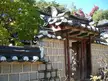 Dosan Seowan student dormitories featuring a traditional Korean stone wall, tiled roof, and wooden gate