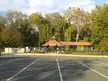Backlick Road station with a red roof building and autumn trees in Fairfax County, Virginia