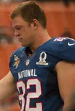 Rudolph wearing a blue National Pro Bowl football jersey with number 32 in a stadium with orange seating