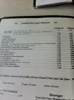 Close-up of a Sandwiches and Platters menu page featuring various burgers and sandwiches on buns