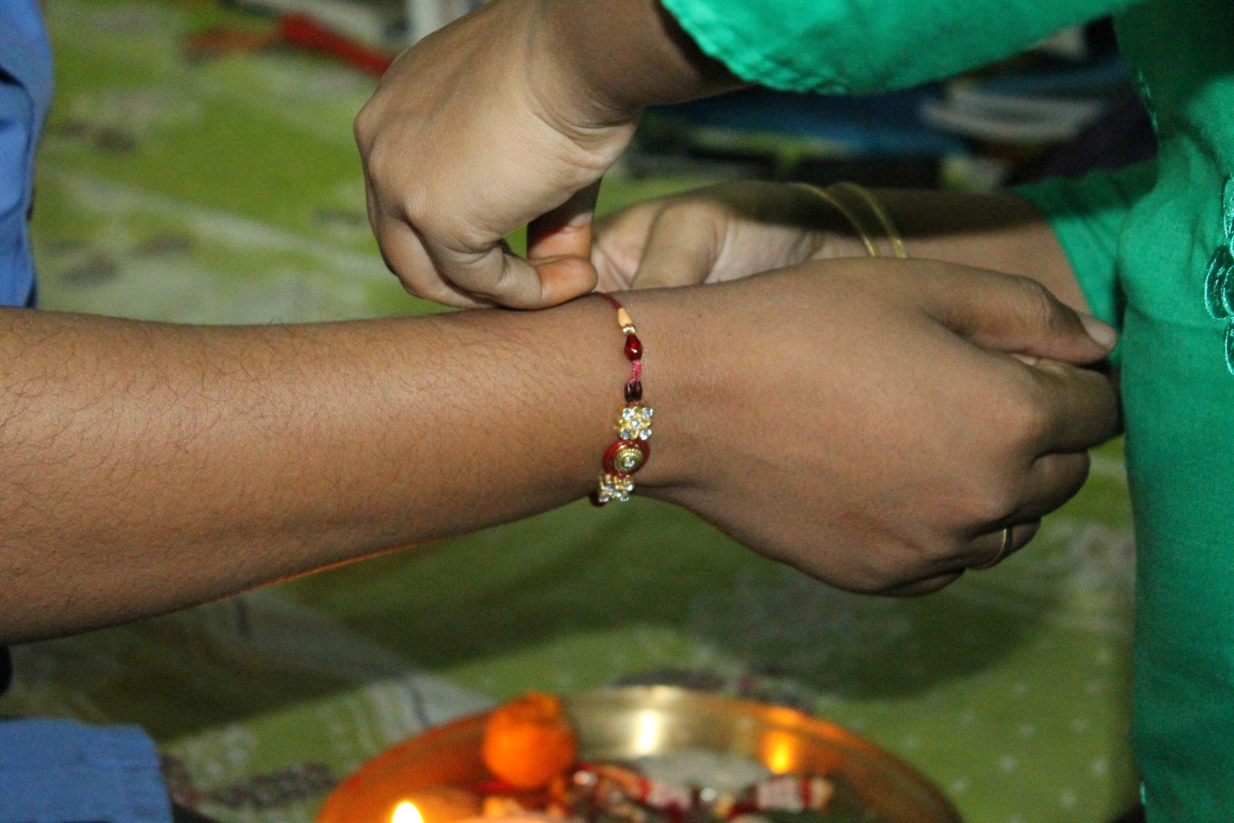 A rakhi being tied during Raksha Bandhan
