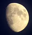 A close-up of a waxing gibbous moon against a dark night sky, ideal for a space desktop wallpaper 4k.
