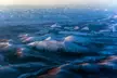 Aerial view of the Verkhoyansk Range with snow-covered mountains and intermontane basins.