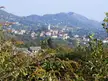Coassolo Torinese village with a church tower and houses nestled in the hilly Piedmont mountains