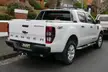 White Ford Ranger Wildtrak 4x4 pickup truck on a residential street