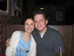 Rob and Gina smiling together in a restaurant booth with graffiti on the walls