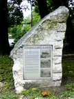 Tuckahoe Marble Quarries exhibit featuring a rough-hewn white marble slab and informational plaque in a wooded area