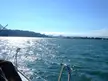 City skyline and hills viewed from a boat on sparkling blue water