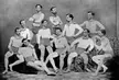 Turners in vintage athletic wear, including tight-fitting shirts and short shorts, posing in a group.