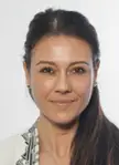 Giusy Versace, an Italian woman sprinter with long dark hair wearing a white patterned blazer.