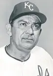 Charlie Metro in a black and white professional portrait wearing a KC baseball cap and jersey.