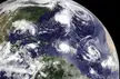 Satellite view of the North Atlantic Ocean showing hurricanes Danielle and Earl among swirling cloud formations.