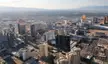Las Vegas Strip aerial view featuring skyscrapers, hotels, casinos, and the Wynn, with mountains in the distance