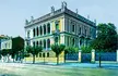 Schliemann mansion 1900, a fine art oil painting of a classical building with roof statues and a street fence