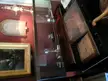 Charles Dickens Museum interior featuring a vintage wooden desk with a glass display case and silver goblet