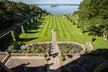 Tjolöholm grounds featuring a manicured lawn, topiary shrubs, and a lake with islands