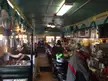 Monarch Diner interior with people at the counter and stools decorated with blue tinsel garlands