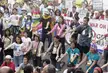 World Social Forum protesters in streetwear, including white shirts and ripped blue jeans, holding banners on a street