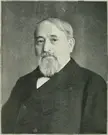 Francis W. Palmer in a black and white gravure portrait wearing a dark suit and white shirt