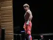Tanaka in red boxing pants and white hand wraps standing in a boxing ring