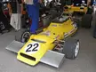 Graham McRae's Leda GM1 yellow vintage race car numbered 22 in a pit area with crew members