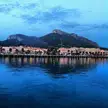 Golfo Aranci coastal town with colorful buildings at the base of a mountain at dusk