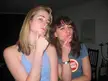 Briony and Dani making funny faces indoors, one with blonde hair in a tank top and one with brown hair in a t-shirt
