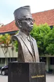 Bronze bust of Ki Hadjar Dewantara on a pedestal in front of Sekolah Tamansiswa