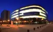 Czech National Library of Technology featuring a curvy modern building and a rectangular building in a night plaza