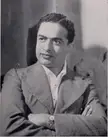 Shantaram in 1938, a black and white vintage photo of a man with dark curly hair in a suit jacket and luxury watch