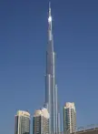 Burj Khalifa skyscraper towering over residential buildings in Dubai under a clear blue sky