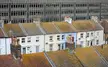 Colorful terraced houses with tiled roofs and chimneys viewed from the Arndale Centre in Eastbourne.